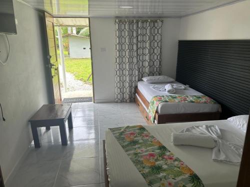 Postel nebo postele na pokoji v ubytování Hotel Nuquimar