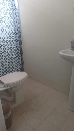 a bathroom with a toilet and a shower and a sink at Hotel villa 15 in Las Victorias