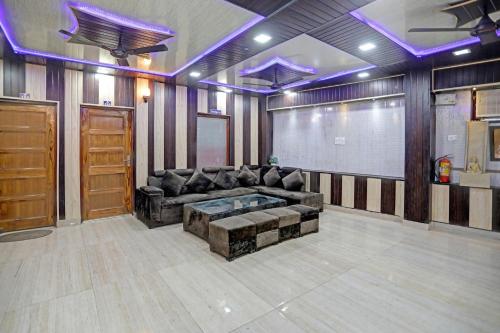 una sala de estar con un sofá y una mesa en Hotel O Vrishti Hotels by Ananda, en Sūrajpur