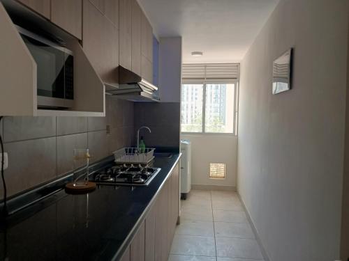 a kitchen with a stove and a counter top at Hampiwasi in Miraflores