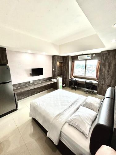 Ένα ή περισσότερα κρεβάτια σε δωμάτιο στο Nagoya Mansion Residence with City View