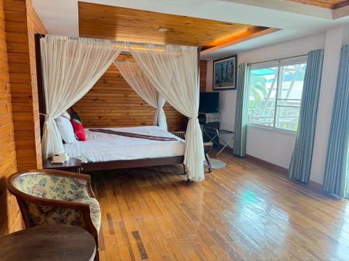 a bedroom with a bed with a canopy at Maekhong Delta Boutique Hotel in Mae Sai