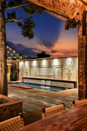 a building with a swimming pool at night at The Inn of Five Graces in Santa Fe