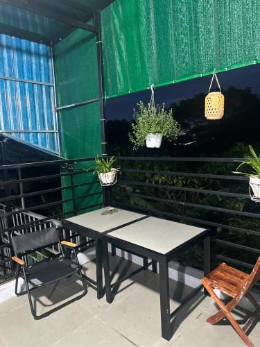 a table and chairs and plants in a tent at Happy House Sài Gòn in Ho Chi Minh City
