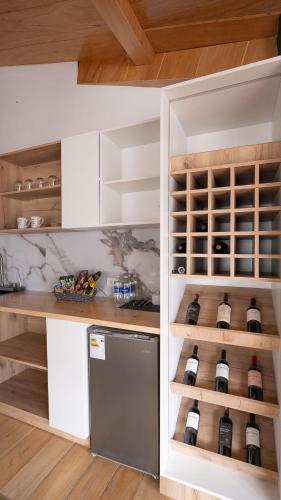 a kitchen with a counter with wine bottles at Namora Domo Experience in Cajamarca
