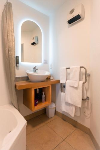 a bathroom with a sink and a mirror at Tussock Peak Lodge in Hanmer Springs