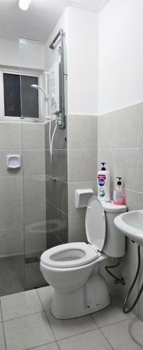 a bathroom with a toilet and a shower and a sink at Alanis Suite KLIA With Neflix in Sepang
