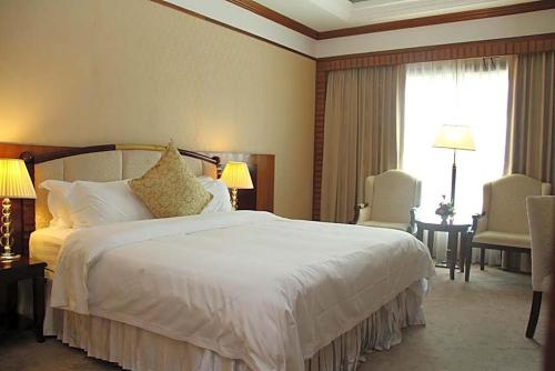 Postel nebo postele na pokoji v ubytování Don Chan Palace Hotel & Convention