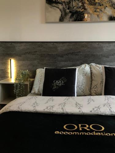 a bed with black and white pillows on it at Birmingham City Centre 2-Bed with Private Balcony in Birmingham