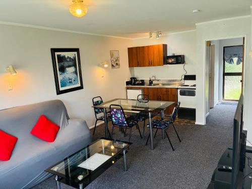 a living room with a couch and a table at Awatea Park Motel in Palmerston North