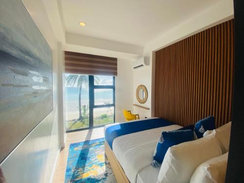 a bedroom with a bed and a large window at V Boutique Hotel Boracay in Boracay
