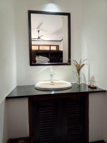 a bathroom with a sink and a mirror at Le Charme Pakbeng Villa in Pakbeng