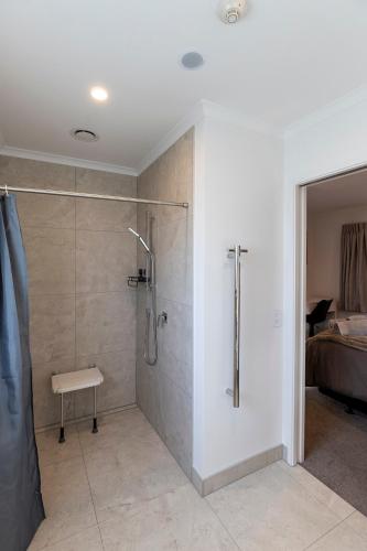 a bathroom with a shower with a glass door at Central Studios in Westport