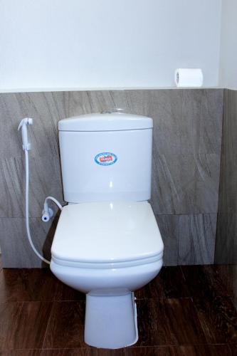 a bathroom with a white toilet in a room at Saara Beach Hotel in Marawila
