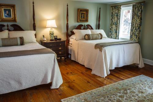 a bedroom with two beds and a wooden floor at Eliza Thompson House, Historic Inns of Savannah Collection in Savannah