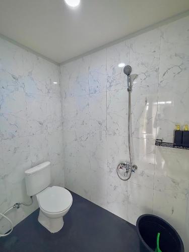 a bathroom with a toilet and a shower at Diiza Glamping Tawangmangu in Tawangmangu