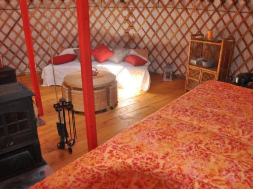 a bedroom with a bed and a stove in a yurt at Mobil-home avec Terrasse au Camping Mas Llinas - API-1-52-373 in Le Boulou