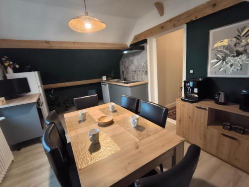 a dining room with a wooden table and chairs at Charmant Loft à La Flèche - Idéal pour Famille ou Couple - FR-1-410-483 in Saint-Germain-du-Val