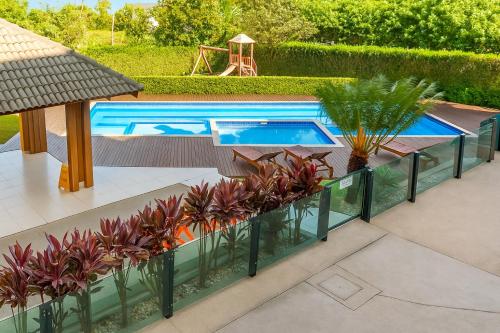 an image of a swimming pool with plants at Refúgio Campodoro in Florianópolis