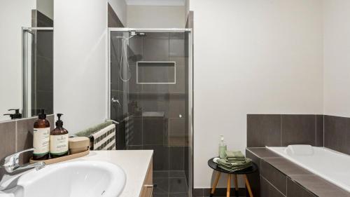 a bathroom with a sink and a shower at Regal Retreat in Saint Leonards