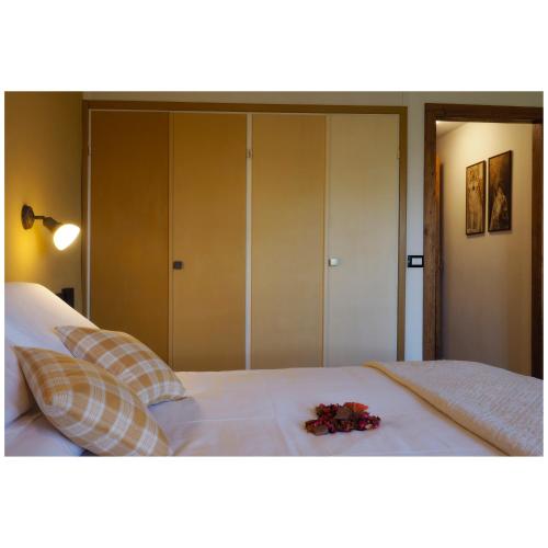 a bedroom with a white bed with flowers on it at Locanda Il Rustichello in Mulazzo