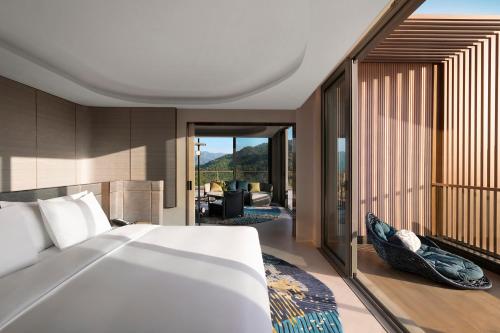 a bedroom with a bed and a living room at Hotel Indigo Anji by IHG in Anji