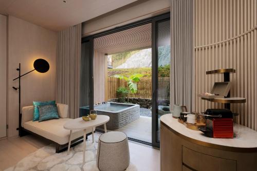 a living room with a couch and a tub at Hotel Indigo Anji by IHG in Anji