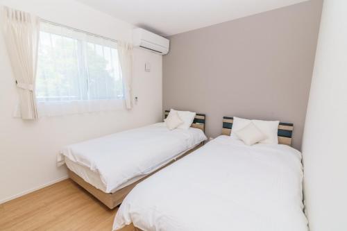 Ένα ή περισσότερα κρεβάτια σε δωμάτιο στο Burikina Terrace N