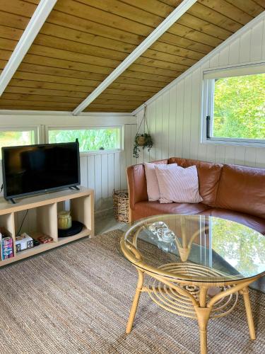a living room with a couch and a coffee table at Kalmar House On Fejø Near The Beach in Vesterby
