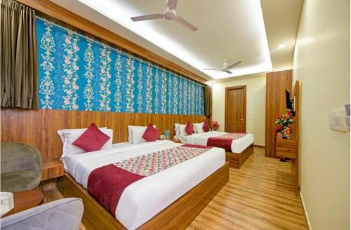 a hotel room with two beds and a window at Hotel Red Plaza -Near Delhi Airport & Free Airport Drop in New Delhi