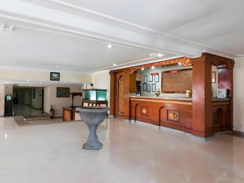 a large room with a fountain in the middle of it at Maha Jaya Hotel Bali in Denpasar