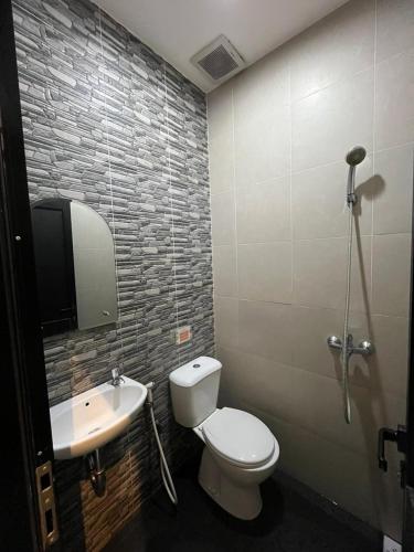 a bathroom with a toilet and a sink at The Cabin Tanjung Yogyakarta in Yogyakarta