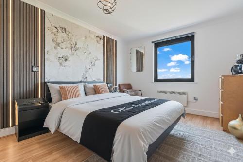 a bedroom with a large bed and a window at Birmingham City Centre modern apartment in Birmingham