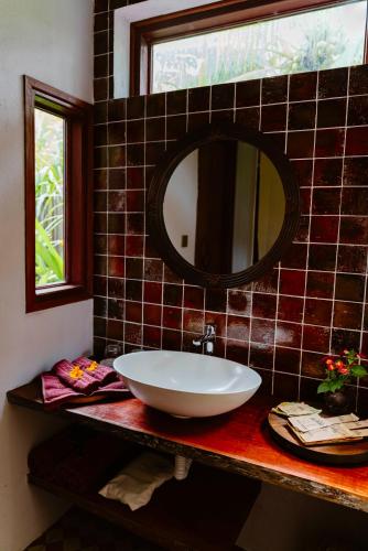 a bathroom with a sink and a mirror on a counter at Thala Tra Vinh in Trà Vinh