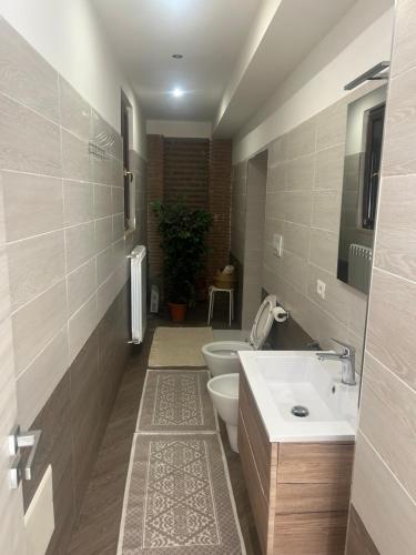 a bathroom with two toilets and a sink at I luoghi di Lisetta in Montefusco