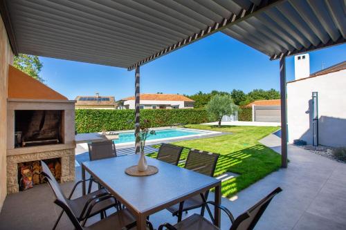 a patio with a table and chairs and a pool at Casa Cassianus - Happy Rentals in Sveti Petar u Šumi