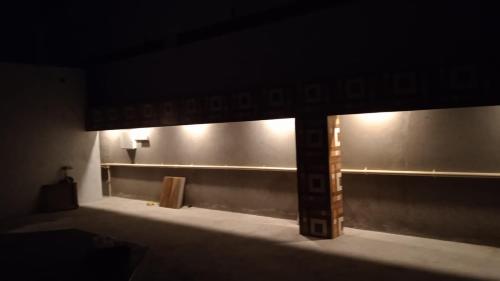 a dark room with some lights on the wall at RKVilla in Tirupati