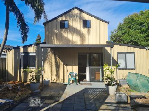 a house with a patio in front of it at Fully Self Contained Guesthouse Retreat in Fishing Point