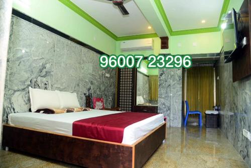 a bedroom with a large bed in a room at Gugan home stay in Tiruchchendūr