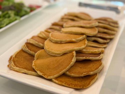 a pile of pancakes on a white plate at Luna Hut Resort in Hua Hin