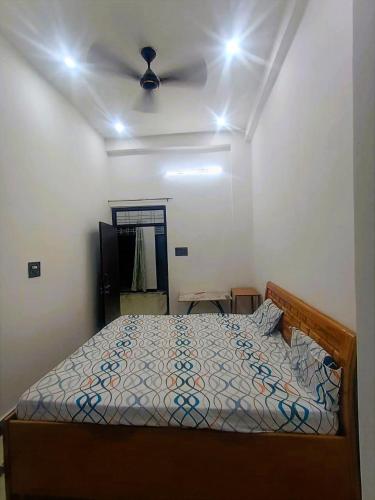 a bedroom with a bed and a ceiling fan at Brij Home Stay in Govardhan