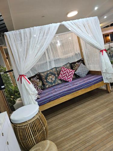 a couch with pillows on it in a room at Casa Amoris Dos in Los Baños