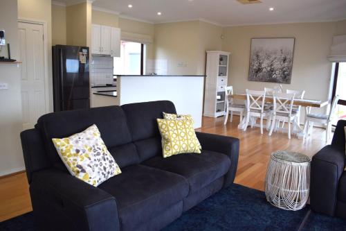 a living room with a couch and a kitchen at Chapel Street Lighthouse in Cowes