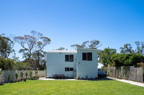 een huis in een tuin met een hek bij Tenby Point Waterfront Views & Tranquil Garden in Queensferry