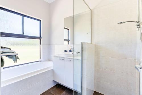 ナナップにあるNannup Rise Holiday Homeのシャワーと洗面台を備えた白いバスルーム