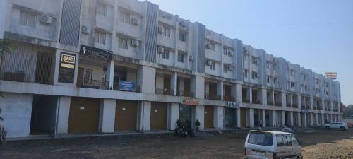 um prédio com um carro estacionado na frente em Namo Guest House em Daman