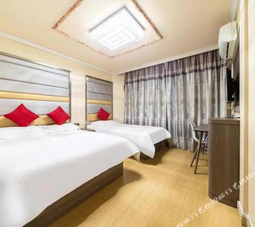 Ένα ή περισσότερα κρεβάτια σε δωμάτιο στο Shanghai Yujia Hotel