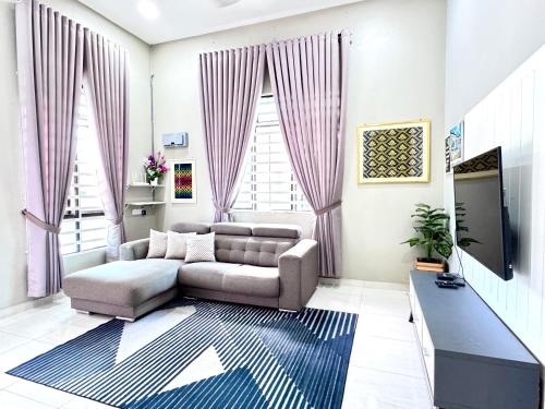 a living room with a couch and a tv at D Palas Timur Homestay 10 Minit Ke Pusat Bandar KB in Wakaf Baharu