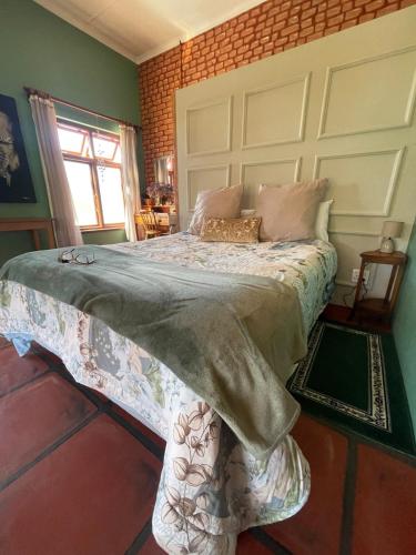 a bedroom with a large bed in a room at Bokmakierie Studio in Montagu