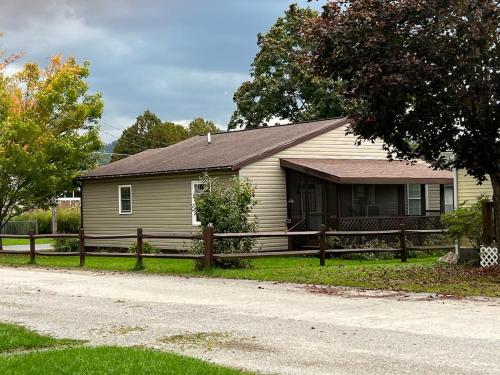 a house with a wooden fence in front of a house at Sir Happy's Place in Elkins